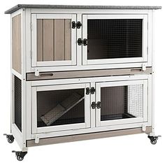 a large white and grey rabbit hutch on wheels