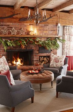 a living room filled with furniture and a fire place in front of a brick fireplace