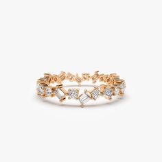 a yellow gold ring with white diamonds on the side and an arrow design in the middle