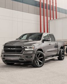 a gray ram truck parked in front of a building