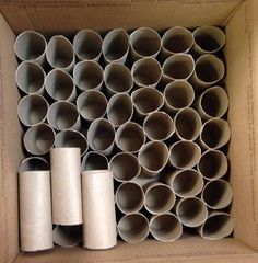 several rolls of toilet paper in a cardboard box