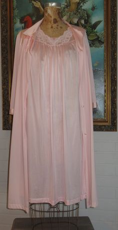 Vintage 1950-60's Shadow Line & Vanity Fair 2 Piece Peach/Pink Robe & Gown Negligee Peignoir. Size will easily accommodate a small to medium, tested on a model 5' 4" tall and 148 lbs. Comfortable fit with plenty of room.  Gown is Shadow Line & knee length, lace trimmed short sleeves, neckline is a modest v neckline with floral lace trimming Robe is Vanity Fair & knee length, 3/4 sleeves with satin trim, full collar, floral applique, one pocket on right side & fabric covered buttons We Are Not Of Vintage Pink Sleepwear For Wedding, Vintage Pink Wedding Sleepwear, Pink Evening Sleepwear For Spring, Pink Spring Evening Sleepwear, Pink Sleepwear For Spring Evenings, Spring Evening Pink Sleepwear, Vintage Pink Robe For Loungewear, Vintage Pink Nightgown For Spring, Vintage Pink Sleepwear For Wedding Night