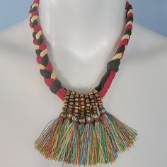 a multicolored necklace with beads and tassels on a mannequin