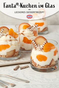 small desserts with orange slices in them on a table