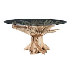 a table made out of wood and glass with a tree stump on the top that has been turned into a coffee table