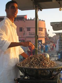 a man is cooking food on an outdoor grill