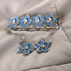 Brand New Blue Flower With Gemstone Accent Earrings & Bracelet Silver Flower-shaped Metal Jewelry Sets, Formal Silver Flower Jewelry Sets, Formal Silver Flower-shaped Jewelry Sets, Blue Flower Shaped Jewelry For Party, Adjustable Light Blue Jewelry For Party, Light Blue Flower-shaped Jewelry With Matching Earrings, Elegant Blue Flower Bracelets, Blue Flower-shaped Formal Jewelry, Adjustable Light Blue Formal Jewelry