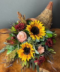 a bouquet of flowers sitting on top of a wooden table