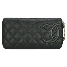 CHANEL Quilted Cambon Long Zipped Wallet Black Calfskin with Silver-Tone Hardware 2012. This stunning large zipped wallet is in good condition. It still holds its original shape, and the hardware is still very shiny. It is such a gorgeous, functional long wallet that it can also be used as a clutch. - Exterior Condition: Good condition, corners show light leather surface wear. The exterior of the wallet shows light fingernail scratches. The patent CC logo shows edges wear. - Interior Condition: Good condition, the interior leather lining shows signs of wear – marks. There are a few marks to the pockets' interior fabric lining. - Hardware Condition: Good condition. The zip pull chain shows surface scratches and light tarnish. - Includes: Box (slightly damaged), dustbag, ribbon and camellia. Luxury Quilted Chic Wallet On Chain, Chanel Wallet, Pull Chain, Interior Fabric, Zip Wallet, Cc Logo, Small Accessories, Long Wallet, Silver Hardware