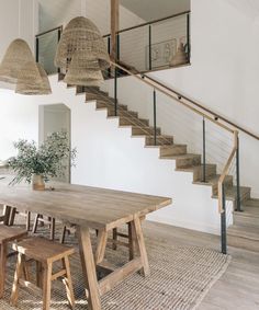 a wooden table sitting under a stair case