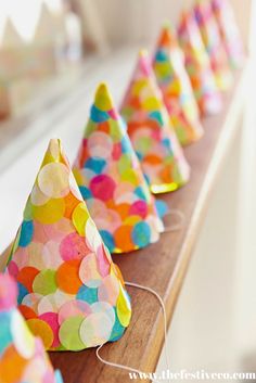 colorful party hats are lined up on a shelf