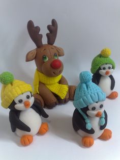 a group of penguins wearing knitted hats and scarves