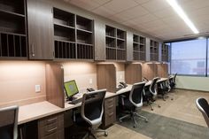 an empty office with desks and chairs