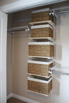 an image of a closet with baskets on the bottom shelf and two shelves below it