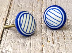 two blue and white ceramic knobs on wooden surface