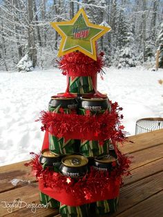 a christmas tree made out of cans in the snow