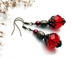 This pretty pair of red earrings will add a touch of vintage charm to any outfit. It is made with red-colored faceted glass beads, small dark red pearly glass beads, bronze-colored metal barrel beads and various bronze-colored metal elements. Metal guaranteed lead and nickel free. Length: 4 cm with clip. 🌹 😉 Don't hesitate to visit my shop "Les Pochons de la Duchesse" to discover my collection of useful and colorful textile accessories: https://www.etsy.com/fr/shop/DuchesseMFC Textile Accessories, Metal Barrel, Colorful Textiles, Glass Bead Earrings, Red Earrings, Faceted Glass, Bead Earrings, Red Glass, Bronze Color