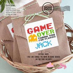 some brown paper bags are sitting in a basket on the table with flowers and an envelope that says, thank you growing for my party jack