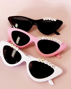 Our beautiful personalized cat eye sunglasses make a cute bachelorette party favor for your bridesmaids - use them as a photo prop for some really fun shots! They're also perfect for the bride to wear at her honeymoon. Each pair of sunglasses comes in your choice of white or beige retro, cat eye-shaped frames and is personalized with letter beads to spell the name/word of your choiceListing is for one pair of cat eye-shaped sunglasses personalized with letter beads.Size: 6"W x 5.75"L Trendy Personalized Party Sunglasses, Sunglasses Bachelorette Party, Sunglasses Bachelorette, Bachelorette Party Sunglasses, Party Sunglasses, Shaped Sunglasses