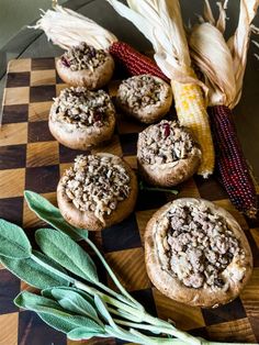 corn on the cob and some cookies are sitting on a checkered board