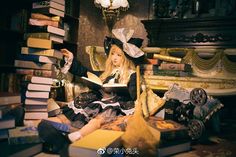 a woman sitting on top of a pile of books next to a lamp and book case