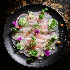 a black plate topped with sliced up fish and veggies