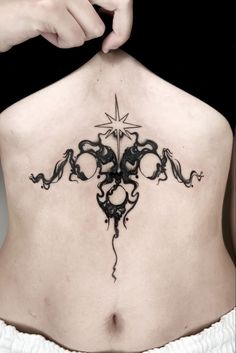 a woman's lower back tattoo with an intricate design on her upper and side