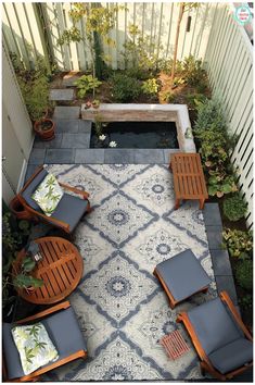 an aerial view of a patio with chairs and a small pond in the middle of it