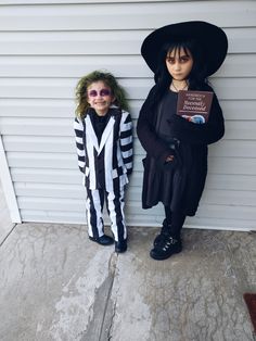 two children dressed up in costumes standing next to each other