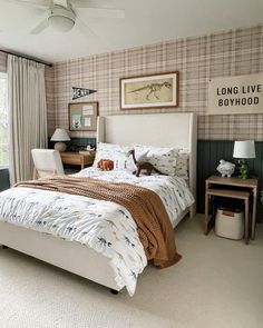 a bed room with a neatly made bed next to a window