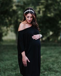 Our boho-chic "Nolita" dress is giving us all of the #momgoals vibes, especially for a mom-to-be! Wear for fall with boots and dress it up for the Holiday season with heals and accessories. This dress is versatile and flattering with a loose fit and cool-mom draped sleeves that fall off the shoulder on one side. You'll love wearing the dress for pregnancy and long after baby bump! Color: Black Floor length, loose fit Off shoulder on one side with draped sleeves Fabric: 95% Rayon %5 Spandex Mater Flowy Maxi Dress For Maternity In Fall, Flowy Maternity Maxi Dress For Fall, Chic Spring Bump-friendly Dress, Chic Maternity Dress For Fall, Black Maternity Dress Bump Friendly, Maternity Black Dress Bump Friendly, Maternity Black Bump Friendly Dress, Maternity Black Bump-friendly Dress, Elegant Fall Party Maternity Dress