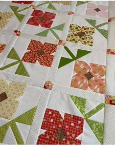 a close up of a quilt with many different designs on it