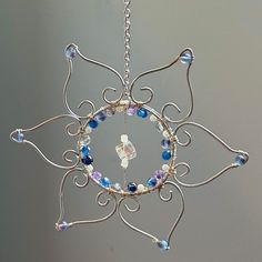 an ornament made out of wire and glass beads