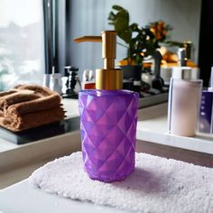 a soap dispenser sitting on top of a towel next to a mirror