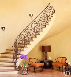 a living room filled with furniture and a spiral staircase