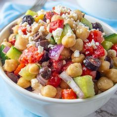 a salad with chickpeas, tomatoes, cucumbers and feta cheese