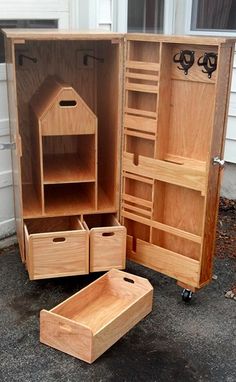 an open wooden cabinet sitting on top of a driveway