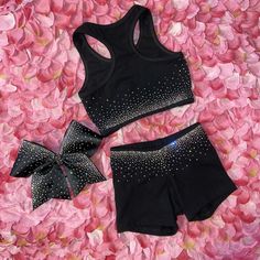 two pieces of black sports bra top and shorts with bows on pink flowery petals