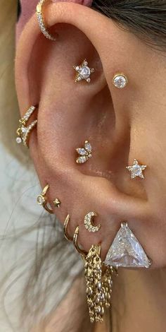 a woman wearing gold ear piercings with diamonds