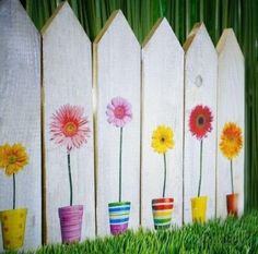 colorful flowers painted on wooden picket fence