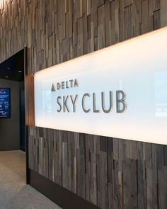 the delta sky club sign is on display in front of a wall with wood panels