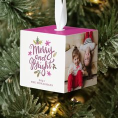 a christmas ornament hanging on a tree with the words merry and bright printed on it