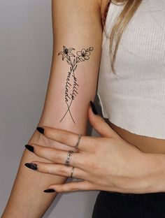 two women with matching tattoos holding each other's hands and one has a rose on it