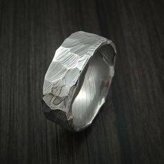 a silver ring sitting on top of a wooden table