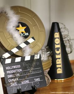 a movie clapper sitting on top of a wooden table next to a black cone