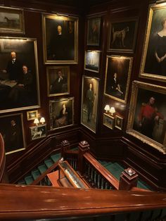 a staircase with many paintings on the wall