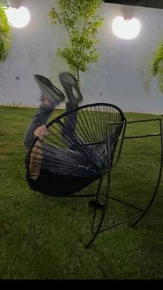 a person sitting in a hammock on the grass