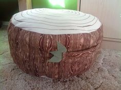 a large wooden stool sitting on top of a carpet covered floor