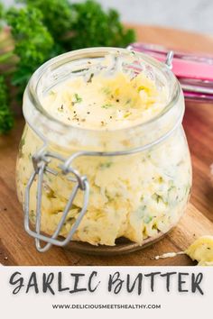 garlic butter in a glass jar on a cutting board