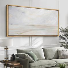 a living room filled with furniture and a large painting hanging on the wall above it